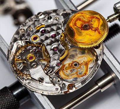 Watch movement held in a movement holder during restoration